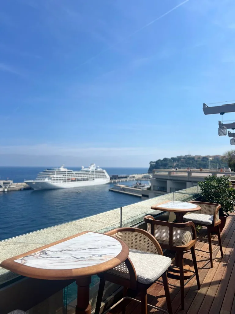 Sunlit terrace tables overlooking the sea