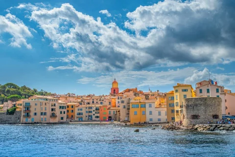 Colourful houses and the tower of Saint-Tropez seen from the sea
