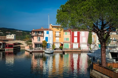 Colourful Port Grimaud façades reflected in a canal
